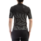 Person wearing a black athletic shirt with a geometric pattern on a white background