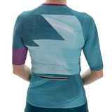 Back view of a person wearing a teal and purple athletic outfit with geometric patterns on a white background.